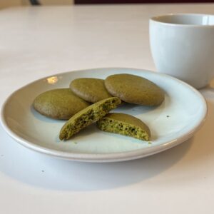 Matcha cookies with lightly brown edge and green, crispy, delicate interior.