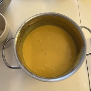 smooth yellow yolk batter with egg yolks, honey, and vanilla extract added to scalded milk, oil, and four mixture