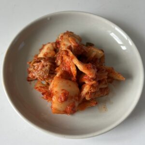 Hot and spicy red cabbage kimchi on a plate
