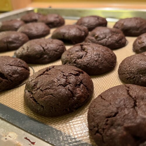 chunky and thick double chcolate cookies on a sheet tray